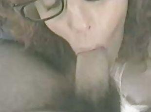 Curly brunette girl in glasses sucks a dick in retro video