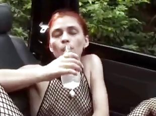 Skinny redhead in fishnets fills her pussy