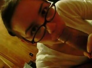 Brunette hussy wearing glasses sucks and rubs a cock in POV clip