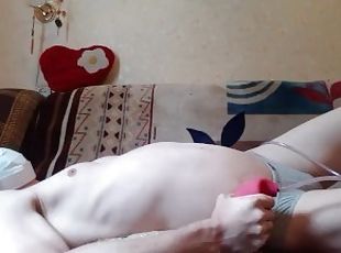 Belly bloated on the bed with a rubber enema