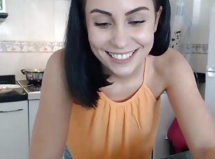 Black haired bombshell cooking on camera for her fans