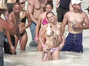 Topless beach party girls enjoy the attention their tits get