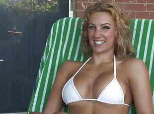 Slutty blonde in bikini shows her fake boobies for the cam