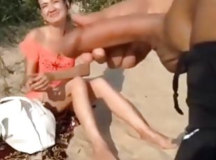 horny guy masturbates at the beach while horny lady watches him