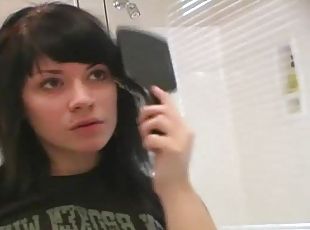Cute raven haired teen teasing in the mirror