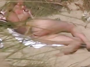 Naked chick at the beach chats on the phone