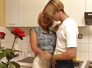 Fucking his busty aunt in the kitchen