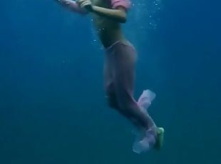 Half naked girls swim in the ocean