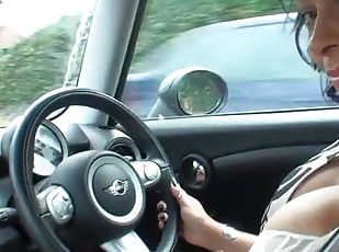 Naughty wife Danica Collins enjoys playing with her puss while driving