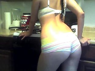 Boyshort panties cling to her ass in the kitchen