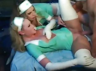 Two latex nurses in threesome