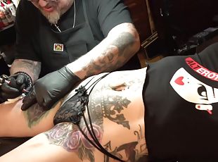 Marie masturbates while being tattooed