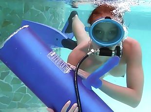 Scuba diving girl in a pool sucks on a dildo