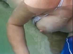 Horny Bella rubs his cock in a public pool